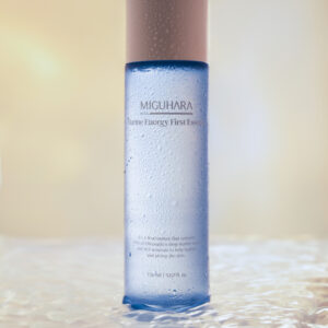 Miguhara Marine Energy First Essence, 150mL, in a sleek, transparent bottle with a marine-inspired design. Formulated with nourishing marine ingredients, this essence is perfect for hydrating and revitalizing the skin as the first step in your skincare routine.