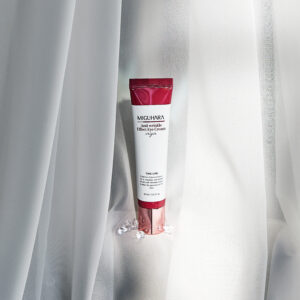 A sleek, metallic silver tube of Miguhara Anti-Wrinkle Effect Eye Cream Origin, 30mL, featuring a precision applicator tip for targeted use. Designed to reduce the appearance of fine lines and wrinkles, this cream offers a luxurious solution for youthful, refreshed eyes.