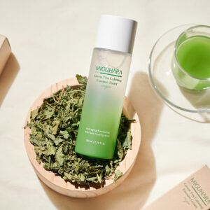 Miguhara Green Tea Calming Essence Toner, 200mL, in a sleek, nature-inspired bottle. Formulated with soothing green tea extract, this toner gently hydrates and calms the skin, making it ideal for sensitive or irritated skin types. Perfect for refreshing and prepping the skin in your daily routine.