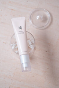 Revive Eye Serum Beauty of Joseon Tube laying on top of a clear plastic container
