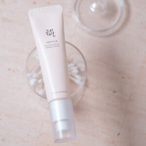 Revive Eye Serum Beauty of Joseon Tube laying on top of a clear plastic container