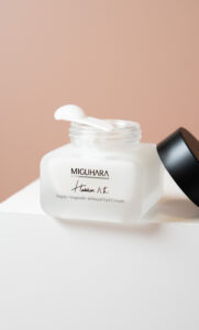 Bottle of 50ml Vegan Ampoule-Infused Gel Cream with open lid and spatula with cream on top