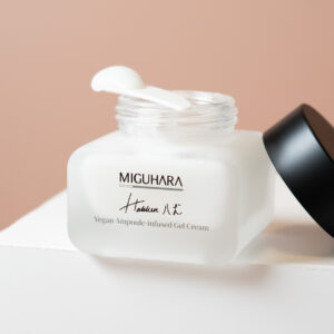 Bottle of 50ml Vegan Ampoule-Infused Gel Cream with open lid and spatula with cream on top