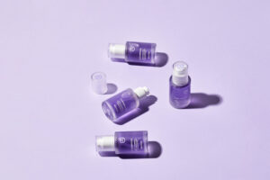 Behydy Plum Ampoule, 30mL, presented in a sleek glass bottle with a dropper for precise application. The design features a plum-inspired theme, emphasizing its nourishing and brightening properties for radiant skin. Perfect for enhancing your skincare regimen.